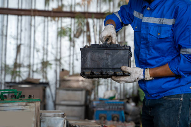Worker repairing car battery,Auto mechanic replacing car battery.